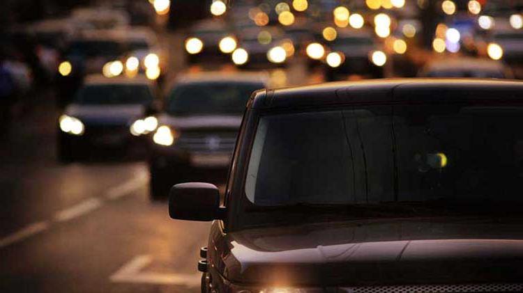 Highway traffic at night with car lights on.